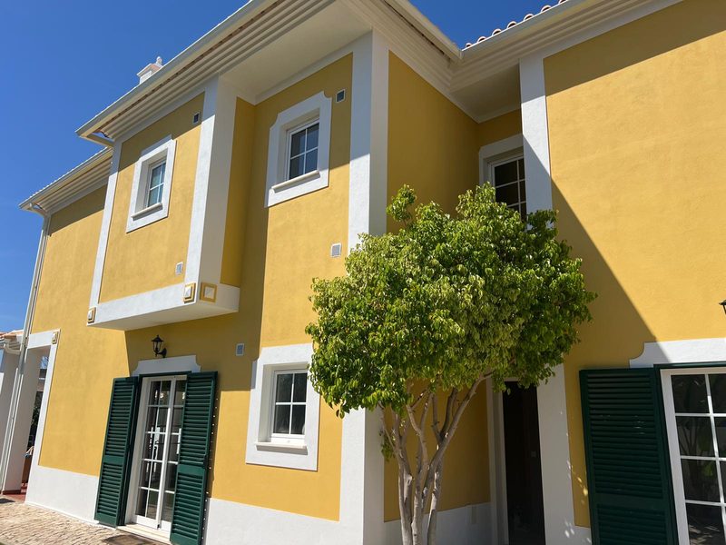 Repainted villa facade in Algoz, Algarve, with white trim and green shutters