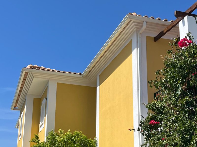 Roofline and corner of a repainted villa in Algoz against an Algarve sky