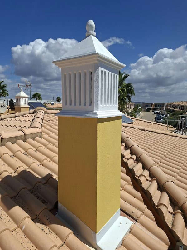 After — chimney 1. Loose paint removed, render repaired, primed, two coats. Crown white, shaft in the colour of the house.